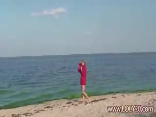 Shy nude teenager on the beach